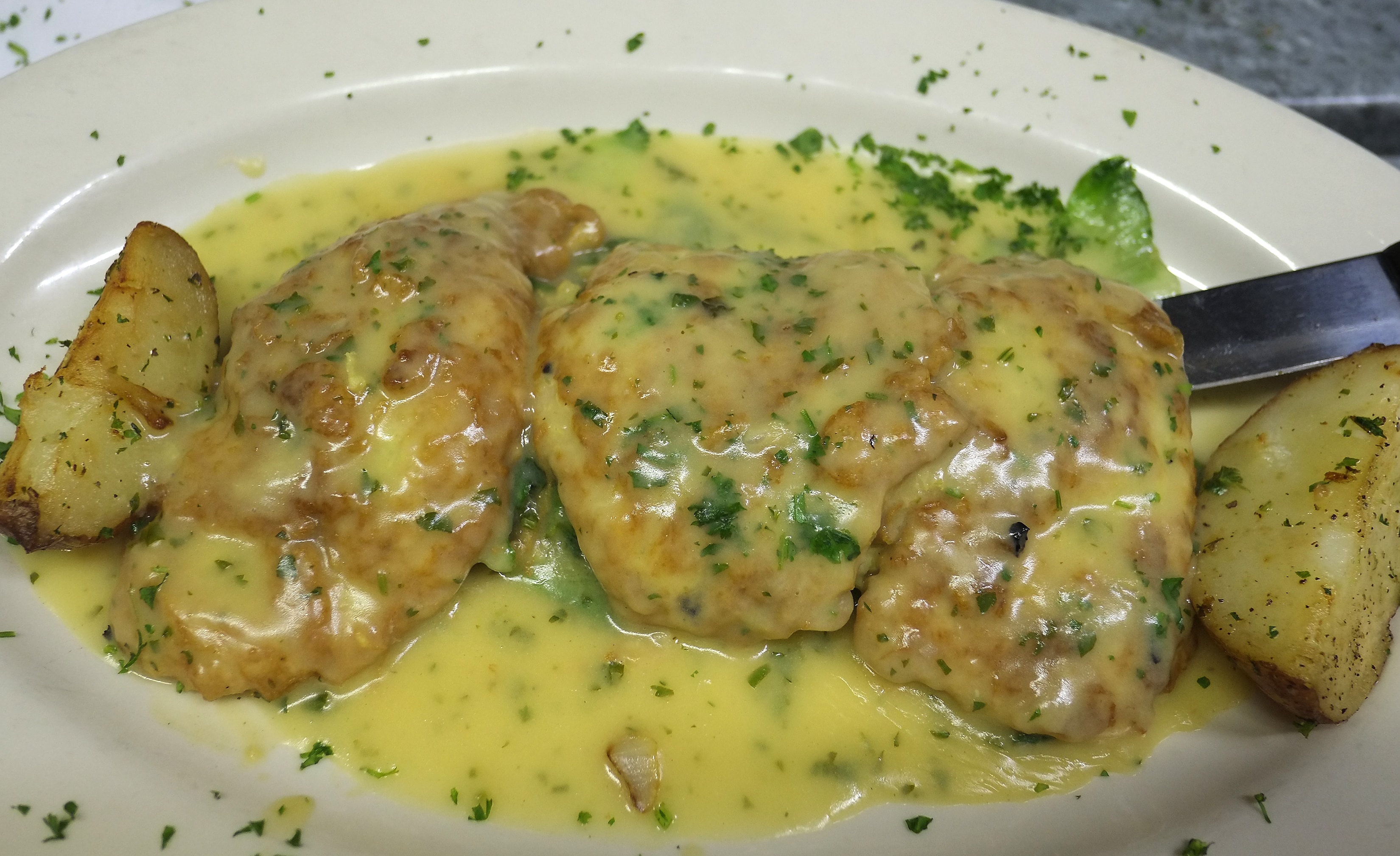 Chicken in lemon butter sauce with roasted potatoes